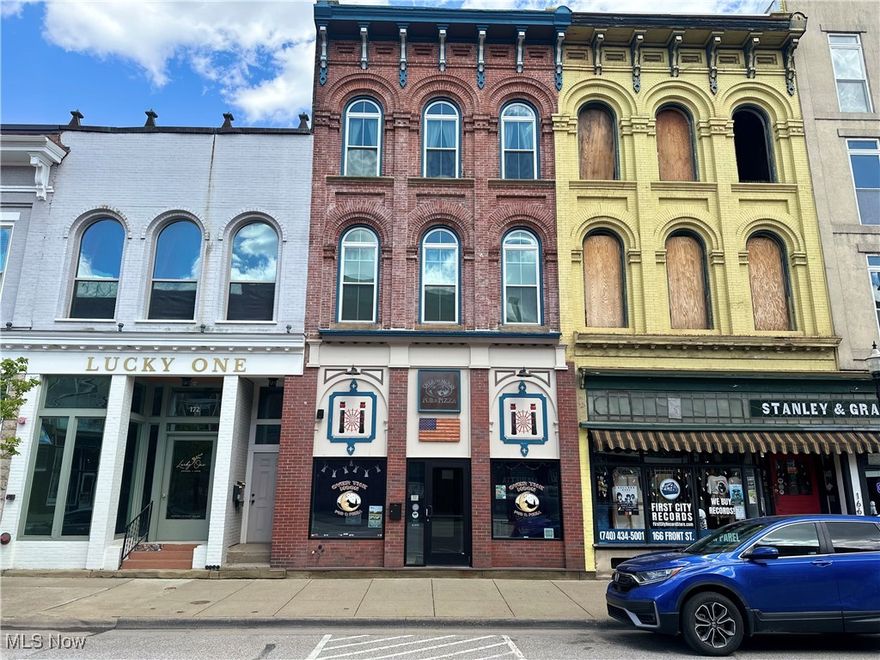 Over the Moon Pub & Pizza is a one-of-a-kind commercial opportunity in the heart of downtown Marietta, OH, offering a fully operational pub and pizzeria on the main level with separate dining and bar areas, a private parking lot, and a spacious outdoor patio for dining and entertainment. This iconic property, known as a staple in the local community, holds exceptional potential for expansion—whether through catering services, food truck ventures, or branding opportunities—especially as the “eat local” movement continues to grow across both Ohio and West Virginia. Extensive property improvements have been made to the interior and exterior since 2020, including a new roof and the complete renovation of the second and third floors. The private living space spans over 3,000 sq.ft. across both levels, featuring hardwood floors, unique historical charm, a full bath on each floor, and a second-floor balcony overlooking the restaurant’s patio, while the third floor serves as a beautifully finished blank canvas ready for customization. This property is truly turnkey with lifestyle flexibility and inspiring investment potential. Contact your buyer’s agent today to schedule a showing and request the investment portfolio—or reach out directly to the listing agent for more details.