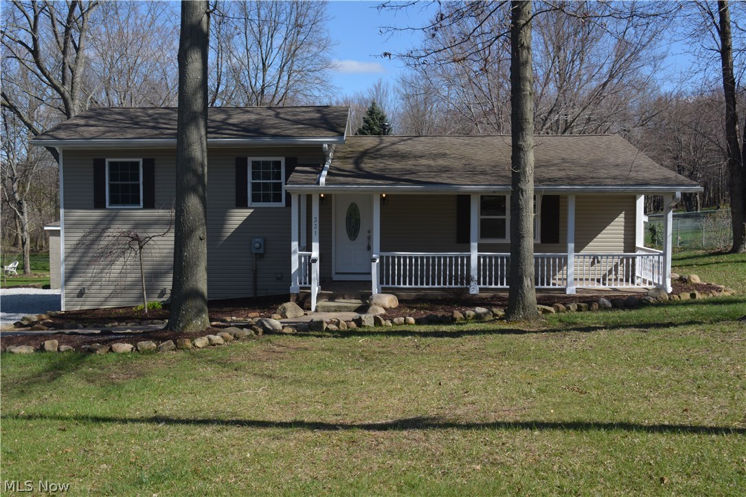 The home you have been waiting for....completely updated and remodeled home in Tallmadge with an acre and a half of great land! Don't miss this one! New hardwood floor look that is actually ceramic tile flooring. Brand new Professionally designed kitchen with soft close drawers and cabinetry, stainless steel appliances, granite countertops, undermount sink and high arc faucet with sprayer, crown mold on cabinetry and tiled flooring that looks like handscraped hardwood flooring! 3 bedrooms could be used as a 4 bedroom with one wall installed across the open room. 2 full baths all brand new! Great lighting and designer paint colors and carpet and flooring professionally chosen! 2 car detached garage ready for your use with plenty of storage and easy access into the home! Pex plumbing throughout, updated electrical and all new baths, kitchen, paint, flooring, etc. GREAT curb appeal and plenty of parking! Awesome home for entertaining due to awesome floorplan and always entering onto ceram