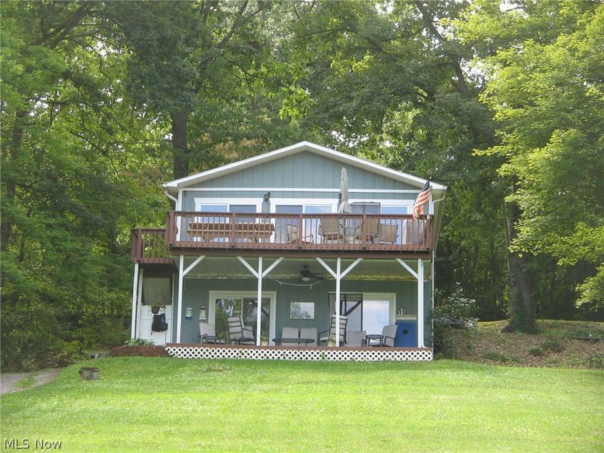 Great opportunity for year round residence or Summer Lake House. This Lake Front 3 bedroom 1.5 bath home sits over looking the private 150 Acre Lake known as Lake Tomahawk. The main house has 3 levels with great views of the lake. 2 car attached garage and a 6 car detached garage with upstairs storage and a summer bunk house. Nestled on a double lot, the property includes it own private dock, boat lift and jet ski platform. Multiple decks, storage shed at lake level for boating equipment, balconies and more. visit the association website to learn more about one of Columbiana Counties best kept secrets. Marina, club house recreation areas all included with HOA. Water Ski Tubing and Jet Ski in your own Private lake Community.