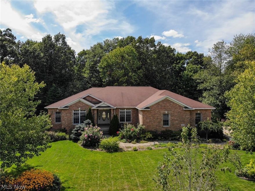 Awesome custom ranch home conveniently located in University Woods couple blocks off front campus of Kent State University! Many features built into this walk out lower level gorgeous ranch home, 3 to 5 bedrooms & 3 full bathrooms including one floor living at its finest, over-sized 2 car garage & plenty of storage. Main level is 2,400 square feet, an additional 1,800 sf finished in walk out lower level + 600 sf of utility & storage area. Gorgeous meticulously nurtured landscaping & raised fenced gardens offer protected organic food sources. All rich brick exterior & placement of large windows, hip roof system & design are an architectural winner! Foyer entry welcomes you into well thought layout flanked by open Dining Room & large Study with built in shelving, hardwood flooring & large closet. Great Room is straight ahead, gorgeous views of the rear yard surrounded by woods & offers many functional furniture placements, opens to the eat-in kitchen, plenty of storage, counter tops & br