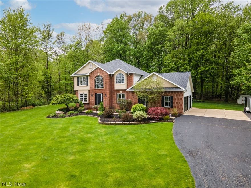 Tremendous 4 bedroom, 2 and a half bath Brick and Vinal Colonial on a secluded 2 acre lot. Many fabulous home features include but not limited to: 2 story foyer with refinished oak floors, split staircase, spacious open concept living room equipped with a wet bar and gas burning fireplace.  
Newly remodeled custom kitchen with Hickory cabinets, granite countertops, stylish stone back splash, stainless steel appliances, center island and a breakfast nook overlooking the private back yard.  First floor finishes with a formal dining room, half bath, laundry room and front sitting room/den.
A gorgeously remodeled staircase leads you to the second floor where you will find a spacious master bedroom containing walk-in closets and en suite master bathroom with a jacuzzi bathtub. Three additional bedrooms and a newly remodeled spare bathroom finish out the second floor. A newer oversized back deck provides scenic views and a retractable awning for those very sunny days. This gorgeous house w