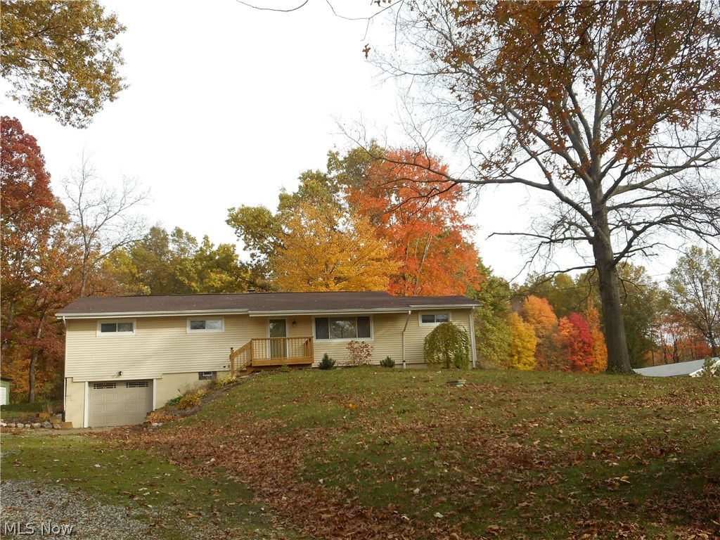 Located in Rootstown Township and on almost 2 acres, this beautiful 4 bedroom/3 full bath ranch home will impress you! Enjoy the sunsets through the picture window in your spacious living room with built-ins and new carpeting (2015); awesome bright and applianced eat in kitchen offers plenty of cabinets and counter space, under mount lighting & built ins - perfect for entertaining. There's also a door off the kitchen where you will find a covered patio and the beautiful backyard to enjoy and watch the wildlife. The updated master bath features a huge walk in ceramic tile shower and double sink vanity. The other full bath on the main level has been updated as well to include a jetted tub. Don't need 4 bedrooms? Use one as an office/den/exercise room. The walk out basement features a full bath with walk in shower, room for storage, and amazing space (currently used as a workshop). Other improvements include new roof (Oct 2016), refinished wood floor in child's bedroom, front d