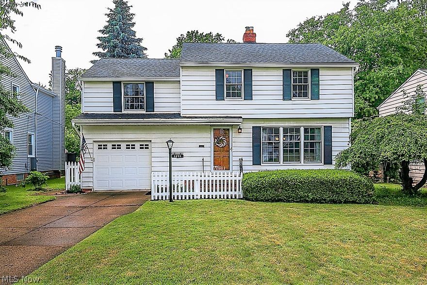 WELCOME HOME~updated and MOVE IN READY!  This one will not disappoint! Very highly desired street and location!  Adorable curb appeal complete with your own white picket fence!!  Gleaming hardwood floors on both first and second floors.  Fireplace in living room and large picture window to take in the neighborhood.  Full size dining room leads to renovated white kitchen with all appliances included, granite counters and cozy eat in area.  Vaulted sun porch expands your space with views to backyard and access to brick patio and a porch with overhang.  Lush landscaping with nice privacy! Guest half bath on first floor and  attached extra deep garage.   All bedrooms can be found upstairs and share an updated bath. Owners suite is huge with double closets! Bedrooms are ample in size with another having double closets as well (original master), closet organizer and access to walk up attic.  Plenty of storage in full basement as well and is light and bright with W/D included!  *Renewal By An