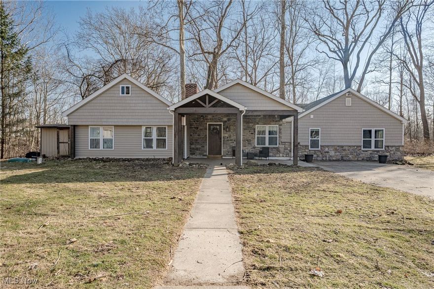 A Stunning, Fully Renovated Ranch! This beautifully updated ranch in Hudson offers over 2,000 sq ft of modern, sophisticated living with 4 bedrooms, 2.5 bathrooms, and a thoughtfully designed open floor plan. A welcoming front porch leads into the foyer, opening to a bright and airy main living area with a striking cathedral ceiling. Abundant natural light fills the space, highlighting the stylish finishes throughout. The living room features a stone fireplace with a gas insert and a sliding door to the side patio, creating a warm and inviting atmosphere. Step up to the remodeled kitchen and dining area, where LVP flooring, sleek cabinetry, granite countertops, and a center island with a butcher block top add both style and function. A sliding barn door leads to the convenient laundry room, while a half bath is just off the foyer. The private primary suite includes a walk-in closet and an updated ensuite bath. Three additional bedrooms share a second full bath, offering ample space for family or guests. Outside, the oversized garage—recently built with three roller doors—provides space for up to four vehicles. The home sits on a generously sized lot, set back from the road for added privacy. With extensive interior and exterior renovations, this move-in-ready home combines modern elegance with timeless charm. Don’t miss out on this exceptional opportunity!