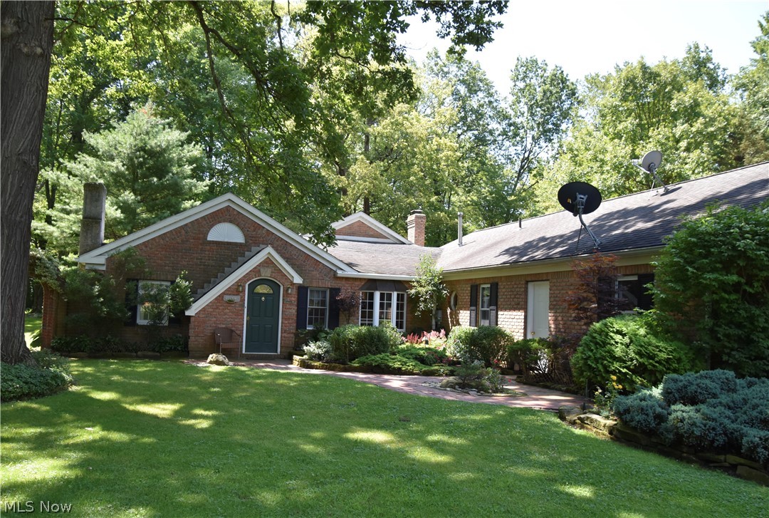 One of a kind property, custom brick ranch nestled back in the woods on 2.22 acres of land. Relax outdoors on your front porch of your charming he/she shed, completely screened in with rustic raw wood walls, ceramic tile floors, and a stone fireplace with a wood burner insert. The yard is scattered with beautiful perennial gardens and mature trees. Whether you are looking for seclusion or a home where you can keep your animals, this is the one! Cozy living room has a full wall gas fireplace, pillars opening up to the dining area which has nice crown moldings. Kitchen has warm, dark cabinets with under and over mount lighting, stainless steel appliances and a custom tiled countertop for bar stool seating. There is a small office area, mud room and another full bath off of the kitchen area. Small sewing room/storage. The highlight of this homes interior is the cathedral ceiling great room addition on the back of the home. 2 full walls of windows stream natural light and french doors lead