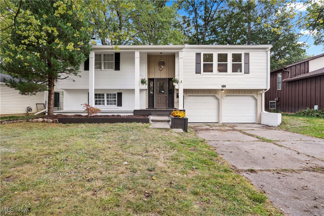 Nestled on a low traffic street in one of Elyria's most convenient locations placing you just minutes from highways, schools, parks and daily convenience shopping! Great curb appeal with a recently refreshed exterior with a front porch complete with stately columns! Enter a freshly updated interior! Open floorpan in the main area! Spacious great room concept with an open kitchen/living/dining room with pretty LVP flooring and lots of windows to radiate natural lighting! Beautifully appointed kitchen has a great layout with a center island w/butcher block counter! Tile backsplash! Patio doors lead to a recently rebuilt balcony/deck! Spacious recently remodeled full bath with a tile shower, newer vanity/floor! The lower level is the perfect space for a teen/in-law suite type setup. There is a family room with unique corner fireplace and a 4th bedroom/second full bath. Attached 2 car garage. Backyard is spacious and has no direct rear neighbors, backs to Metro Parks owned land! Central air unit will be replaced soon!