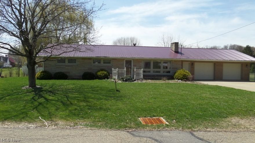 Beautifully updated 3 Bedroom, 2 Full Bath Brick Ranch, metal roof, custom window treatment. newly refinished kitchen, family room and living room both have a fireplace, dining room, laundry room, central air, 2 car attached garage,concrete drive, brick patio off family room w/wooden deck, outbuilding, walking distance to schools, on almost an acre.