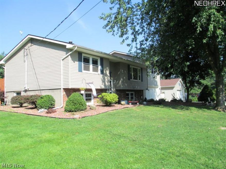 Split level set on 4.4 acres with amenities galore!  Take a look, you're sure to love the spacious master bedroom featuring a beautiful ceramic master bath with walk-in shower and walk-in closet, 2nd bedroom has large closet plus sliding door to HUGE deck and hot tub.  Oak kitchen with dishwasher and dining area with sliders to the deck and above ground pool makes it ideal for grilling out and pool parties!  Partially finished basement offers a family room with pellet stove, full bath with jacuzzi tub, 4th bedroom or office and a 2nd kitchen - perfect for canning, entertaining or the teenager/adult that wants their own space.  Attached garage plus a 30x40 pole building - plenty of parking for the boat or RV!  A/C, water filtration system and stocked pond.  E-Z access to I-90.  4 bedrooms, 3 baths, wooded, private - move-in ready.