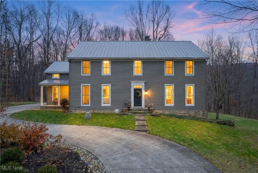 Welcome to your one-of-a-kind slice of paradise. Tucked a tenth of a mile into a tranquil wooded setting within a quiet neighborhood, this property offers a rare blend of seclusion and convenience. While you'll feel worlds away, the home is just a four-minute drive from Interstate 71 and a comfortable 22 minutes from the Cleveland Airport. Step inside to discover the warmth of Brazilian cherry hardwood floors that flow throughout the ground level. The living spaces are bathed in natural light, thanks to custom, expansive, two-story transom windows, ensuring you may find yourself forgetting to switch on the lights. Encompassing over four pristine acres, the property is a true haven. The grounds offer breathtakingly beautiful views and ample yard space, which includes a charming 1830s log cabin.
The main house features four generous bedrooms and four and a half luxurious bathrooms. The gourmet kitchen is a chef's delight, boasting elegant granite and stainless steel countertops, a vaulted ceiling, and abundant space for both cooking and dining.
The basement offers an additional 1000 square feet of finished living space with convenient walkout double doors. This area includes a closed room, perfect for use as an office, bedroom, or dedicated lounge area. A section of the basement is outfitted with durable rubber workout flooring, creating an ideal spot for a home exercise room. Every detail has been curated for comfort and sophistication. Additional custom amenities include a stone fireplace, a dedicated office space, a jetted tub, stone walls throughout the landscape, authentic street paving bricks and stone table on the patio. Let's not for get the extra-spacious three-car garage.

This is more than a home; it’s a private estate designed for those seeking tranquil living without compromising accessibility.