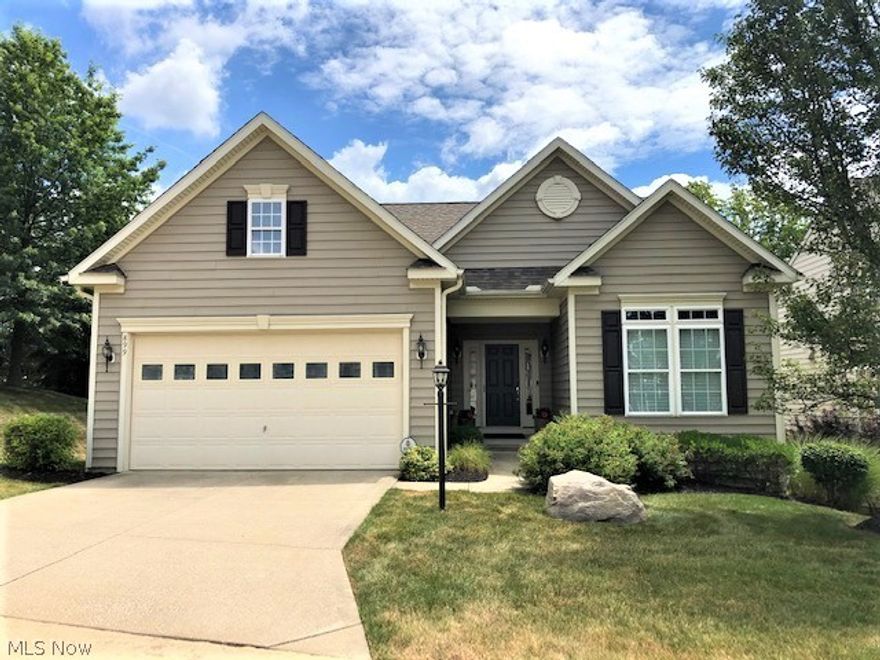 Amazing home with many upgrades, quality finishes and features.   Owner took the original plans and customized the design many times over to get the finished product.   Your main level features a foyer with trayed ceiling, bedroom and full bath off to the right, first floor laundry to the left which attaches to the garage and a spectacular, two story Great room.  The back wall of the great room is accented with columns & arches that frame views of the metro park beyond.   The kitchen is to die for... a combination of Maple and dark stained Cherry cabinets are accented with granite countertops and plenty of cabinets, soft close drawers and accent lighting to come.  High end refrigerator and dishwasher are very new. The breakfast bar counter was made from the wood from a late 1800's bowling alley.  The great room/kitchen area feature wood floors.  The first floor master was extended to include a nice sitting area w/private park view, walk in closet and bath.  The 2nd floor offers a spaci