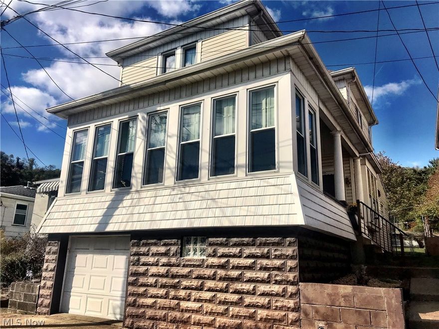 Enjoy your first cup of coffee or tea each morning on your enclosed, climate controlled front porch! The woodwork in this beautiful home will astound you with gorgeous french doors leading to the porch and pocket doors separating the dining and living rooms. This spacious home located just two blocks from Memorial Park has a ton of updates including a brand new kitchen, new floors, a new furnace, new electric, and newer windows. The roof is less than 10 years old and has a thermostatically controlled attic vent. Additionally, there is a new half bath and a utility room on the first floor. Also, if needed, you could make the living room a first floor bedroom! Priced to sell, schedule a private showing today!