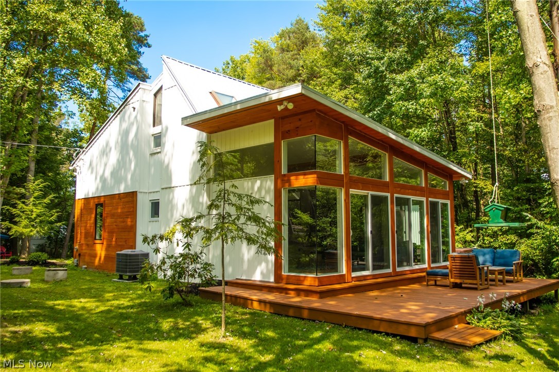 Looking for a home next to the Cuyahoga Valley National Park? This Contemporary 2 story home was designed by Zoltan Balogh, local well known architect and is nestled on over 2+ acres of woods, ravine & a creek. The rear property line backs to the National Park. Huge Great Room boasts vaulted ceiling, floor to ceiling brick fireplace with high efficiency wood burning insert and a wall of sliding glass doors to Deck. Open Kitchen/Dining area with Swedish pine cabinets, quartz countertops built in breakfast bar & newer stainless steel appliances. There's a 1st floor guest bedroom that could be another master bedroom with a walk-in closet and a sliding door to a deck with hot tub (negotiable). The main floor bath has a custom shower with 2 shower heads, a separate jetted tub with ceramic tile and a rustic vanity and sink. In addition, you will find a 7x6 Cedar Sauna with a bench that attached to the bathroom. There's a 1st floor laundry area. As you go up the stairs, there's a small va