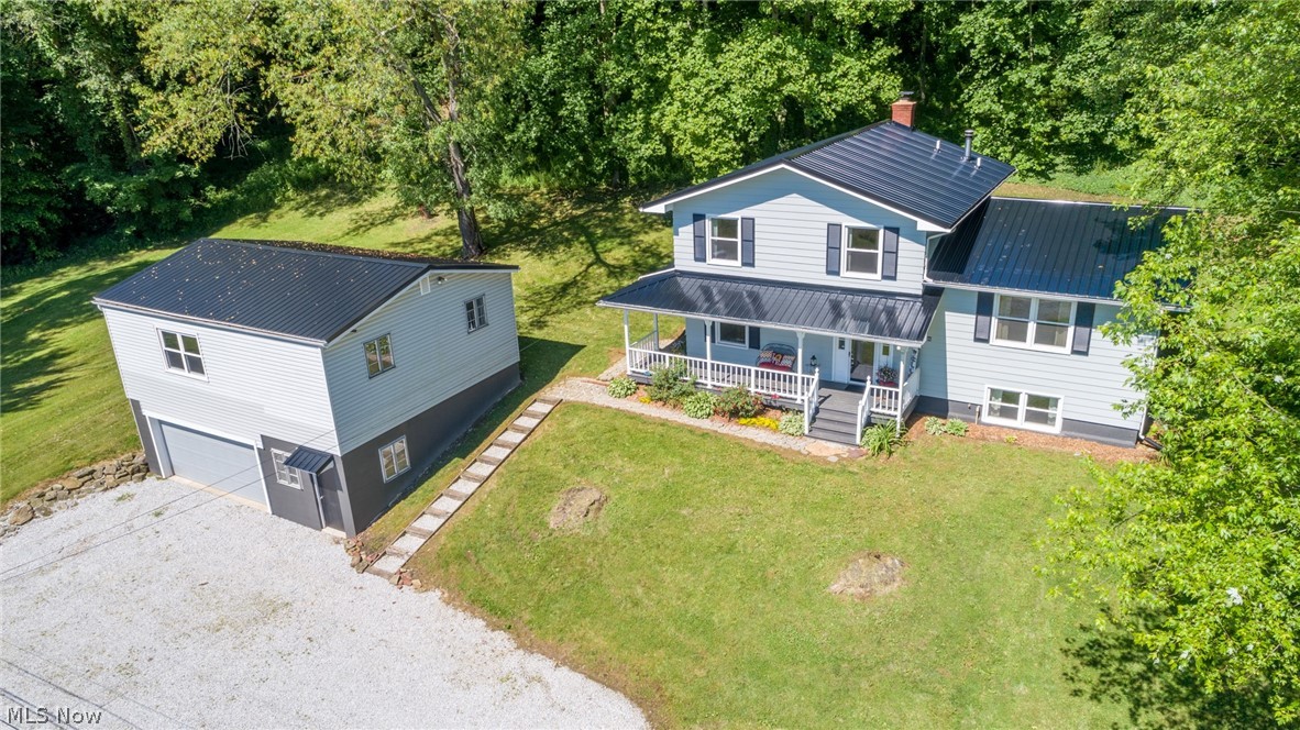 Welcome home to 7.5+ acres of seclusion...without the feeling of exclusion. This nearly 2,000 sqft 4-level split is perched on a private lot with gorgeous views, but is minutes from major highway access for your everyday commute! A charming wrap around front porch offers entry doors into either the main level bedroom or the foyer. Additionally, you'll find a living space with a wood burning fireplace, storage closet and a remodeled 1/2 bath. The lowest level boasts an additional living space and a laundry/utility/storage room. The eat-in kitchen was remodeled in 2018 with gorgeous cabinetry, neutral flooring, counter-tops and back-splash and has a sliding glass door to the deck that overlooks both the wooded backyard views and the sprawling side lawn! A remodeled bathroom and 3 bedrooms, including a master with an en-suite bath are located on the 2nd floor. Updates include: brand new metal roof house & garage, kitchen & bath remodel, flooring, paint, hot water tank, well pump, sump pum