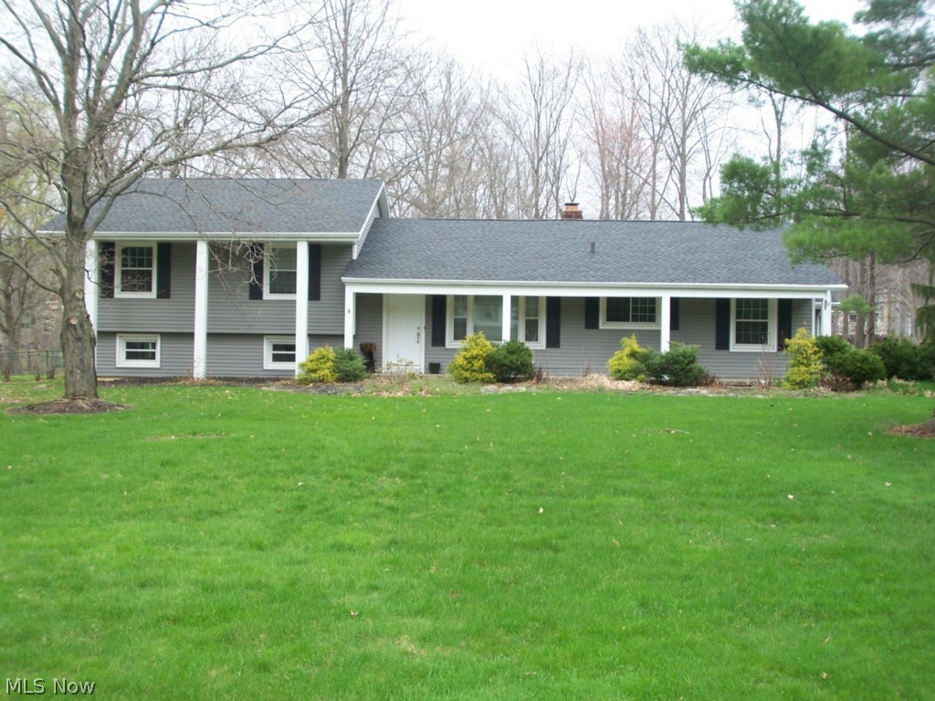 An exceptional Hudson split level on .69 acres. The rear yard is completely fenced, with an amazing patio and hot tub. A huge focal fireplace sets off a large living room. The lower level features a family room, and is a walk out. The large galley kitchen has an eating area. The many updates include: roof, gutters, siding, refinished floors, patio, windows, furnace, and much more. The bedrooms are spacious, with a master suite. There is an attached two car garage, bonus room off of the living room, and a front porch large enough to enjoy.