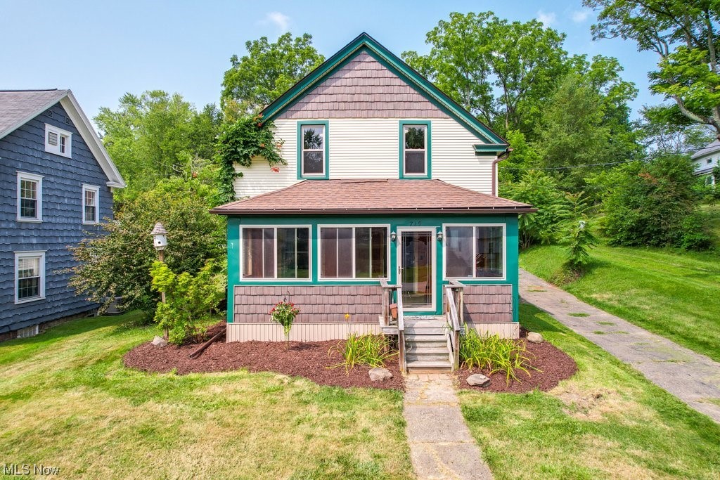 Welcome to this Beautiful recently renovated home within walking distance of downtown Ravenna. Enter through the newly renovated 3 seasons sunroom with updated windows perfect for parade watching or drinking morning coffee. You'll find gorgeous original hardwoods and a beautiful banister in the foyer. The Livingroom and dining room have extra tall ceilings with beautiful crown molding and updated windows throughout. The dining room also has a large window bench with built in shelving, perfect for extra seating for guest or to cozy up with a good book. The first-floor master has beautiful original built ins with leaded glass details and a newly remodeled private en suite bathroom. Charming kitchen with plenty of cabinets and a retro backsplash. Right off the kitchen you can enter through a mudroom that has a door that leads to a partial fenced backyard, perfect for pets. Upstairs there are four large bedrooms with newer flooring and an updated bathroom. Outside you will find a one car