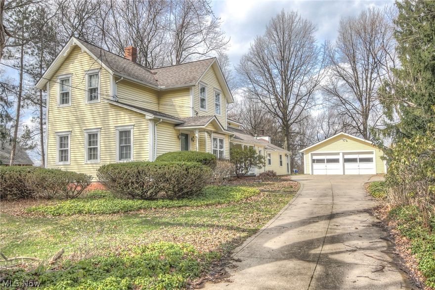 Own a piece of history in a superb location! This beautiful century home offers character + modern convenience. Enjoy an updated kitchen (with all the appliances) that opens to a huge family room with a wood-burning fireplace and beamed ceiling. Hardwood floors throughout most of the first floor take you into a charming dining room and large living room with window seats and built-in bookcases. Plus, there is a bonus room up front with walk-in closet that could serve as an office, playroom, or even an additional bedroom. The home offers 2 full baths (one on each level) and 3 bedrooms upstairs. Conveniently located minutes from I-77 (easy access to Cleveland and Akron), this home is set back off the road with a quiet park-like 1.55 acre lot, a large limestone patio, and lush landscaping. The basement was recently waterproofed and electrical system updated. Other newer items in the last 10 years include: A/C in the addition, roof, gutters, master bedroom skylights, most windows and doors