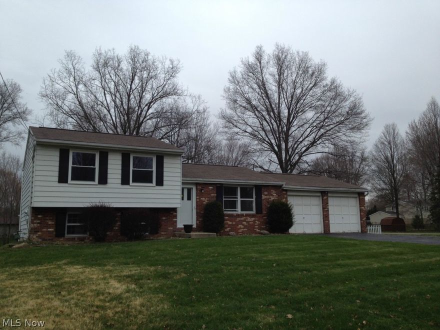 Move in ready! Multi level home on corner lot.  Kitchen has maple cabinets, new stove and microwave. Home is freshly painted throughout with new lighting, bathroom updates. Home has family room on lower level with full bath and walkout to sunroom, carpeted rec room/playroom in basement, concrete patio, storage shed.