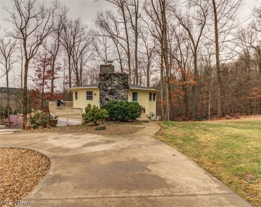 Take a look! Stunning & very unique renovated round house with great curb appeal situated on three lots, a little over an acre of property! Buy now & plan a perfect weekend retreat or live here full time. Tucked away on a quiet street you'll find an open floor plan and vaulted ceilings that gives this home great character. Awesome stone electric fireplace adds much charm. Lake Mohawk is a gated community having a 500 acre lake with unlimited horsepower, three beaches, clubhouse, golf course and tennis courts. Lake Mohawk is located 45 minutes southeast of Akron & 25 minutes from Canton. Enjoy fishing, boating and so much more.