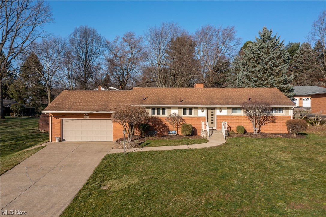 This charming ranch-style home sits on over a half-acre lot in Perry School District. This lovely home is well-maintained, bright, and airy, with lots of character and wood floors throughout living areas and bedrooms. The great room features a corner wood-burning fireplace, large windows with great backyard views, and access to the covered back patio perfect for entertaining. The eat-in kitchen offers windows on both sides, white cabinets, ample storage space, and a convenient half bath around the corner. The main floor is complete with three bedrooms and a full bath with a large vanity and a tiled shower tub combo. Finished basement with a full bath, a laundry area, storage space, and a recreational room with a sitting area, brick gas fireplace, and built-in display cabinets. The attached 2-car garage completes the package. Great location - nearby schools and shopping. Updates include remodeled both bathrooms on the main floor, new flooring in the kitchen, living room, and hallway, re