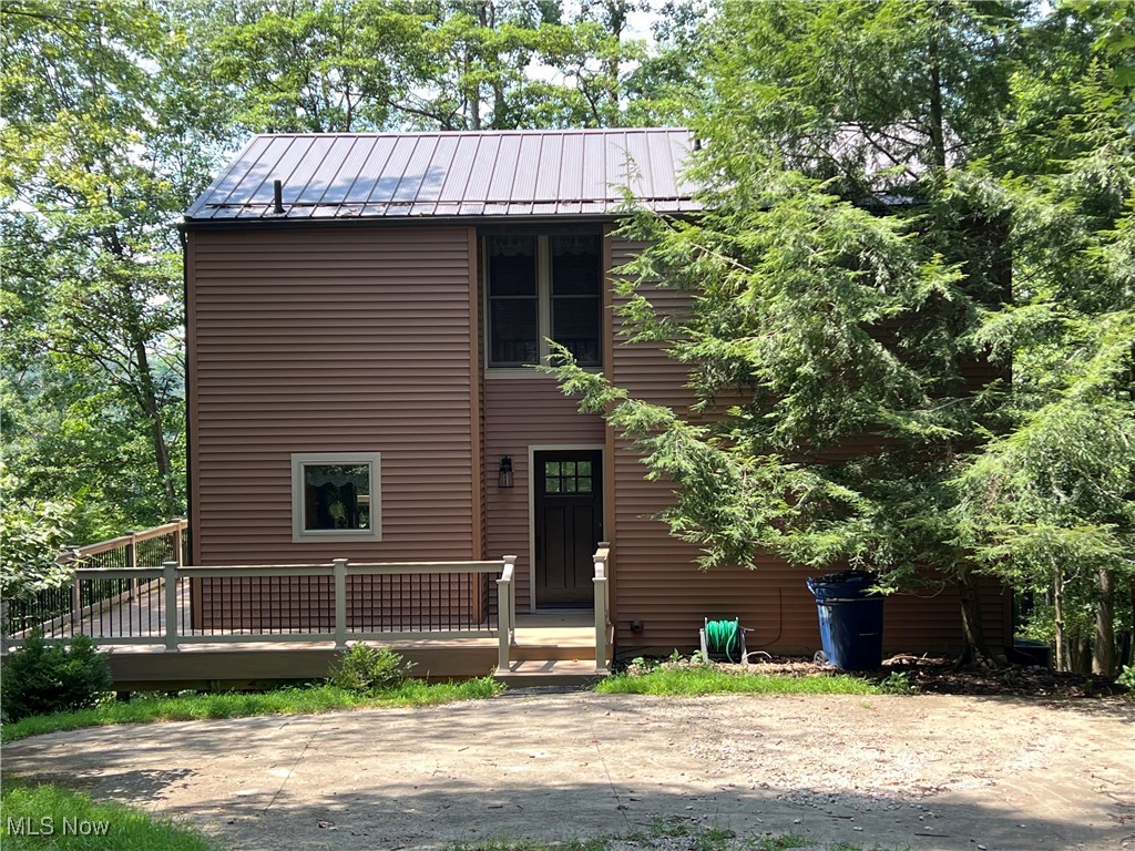Move-in ready 2-bedroom, 2-bath home in the private, gated Lake Mohawk community. A perfect weekend retreat, this property features a bright kitchen with first-floor laundry, open living space with vaulted ceiling, (2023)gas fireplace, and a large composite deck (2023) overlooking a wooded lot with seasonal lake views. Major updates include low-maintenance replacement windows/doors, siding, gas furnace (2023) and a durable metal roof (2023) offering peace of mind. The upper level provides a bonus area full bath and a bedroom. The finished walkout lower level provides flexible living - ideal for a family room, guest space, or home office. Enjoy Lake Mohawk amenities including boating, fishing, swimming beaches, tennis, pickleball, clubhouse, and a manned 24/7 gate. Conveniently located near Canton, this home combines comfort, privacy, and resort-style living in one of Ohio's most desirable lake communities. Don't miss your chance to own a piece of the Lake Mohawk lifestyle!