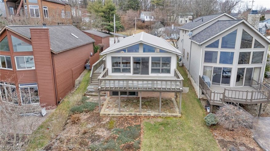 Portage Lakes main chain! One family built and owned -- First time ever on the market!! Try to find a better view! Panoramic lake views on East Reservoir speed zone from this well cared for 3 bedroom 2 bath home with finished walk out basement and covered boat house. New metal roof, tankless hot water tank, and newer siding and Anderson windows. Open floor plan and updated kitchen with granite countertops, newer carpet, and updated private master bath. Lower level recreation room walkout w/ 2nd kitchen for all your entertaining needs. Rare covered boathouse dock with 3 slips. Oversized two car garage with huge driveway for all your guests this summer. Summer is calling...call today and start living your dream on Portage Lakes!