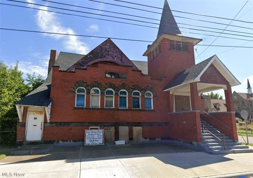 This historic church, originally built in the early 1900s, has been family owned and operated for decades and is now ready for its next chapter of ministry or community use. Situated on the corner of Helena Avenue and East 105th Street, this remarkable place of worship features an extra-large sanctuary with soaring ceilings and beautiful stained-glass windows that showcase its timeless character. The main level includes a spacious pulpit area, multiple office spaces, and a library, offering flexibility for various organizational needs. The finished basement provides a full kitchen, bathrooms, and expansive gathering or recreational areas ideal for events and fellowship. While the property has been well cared for with routinely serviced mechanicals and an updated roof, it will require repairs and renovations to meet modern standards, presenting a great opportunity for restoration and customization. The adjacent vacant lot is included in the sale, adding additional potential for expansion, parking, or future development. A rare opportunity to revitalize a true Cleveland landmark and bring new vision to a historic space.
