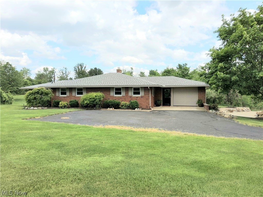 Completely remodeled brick ranch situated on 2 acres. Every inch has been completely remodeled. Throughout the home you will find new hardwood flooring, 5" Poplar baseboards. 6" Crown Molding and Poplar wood window, door and trim accents, all new drywall, ceilings, lighting, doors and can lighting. The Living room showcases a large picture window with views of the pond and direct access to the large deck. The spacious Master bedroom addition has a large walk-in closet featuring natural light and a remodeled Master Bath. The Master features french doors leading out to the deck. Two more bedrooms, a full bath and the remodeled Kitchen finish out the first floor. The Kitchen includes an extra-large granite island with seating and storage, soft close cabinets by Windy Hill Hardwoods, a farm house sink, tile backsplash, stainless steel appliances, a walk-in pantry, under cabinet lighting and a 7' granite breakfast bar overlooking the gorgeous backyard. The partially finished walk-out basement includes a half bath, a bonus living area, a 20 x 20 crawl space. This home has been professionally landscaped. A newly constructed partially covered deck with pergola and hot tub runs the entire length of the home, perfect for entertaining. The deck features large steps to the lower level with storage beneath. The 30 X 40 2-story barn has power, lighting and a chicken coop. The 5/8 acre pond is 13.5" deep and is fully stocked. It is equipped with an emergency overflow and a 6" pipe overflow. New items include: Soffits and Siding, 6" Gutters, Exterior Doors, Double Hung Windows, Trane AC System, McClain Boiler, Hot Water Tank, Aluminum Chimney Sleeves, Exterior Brick Chimney, Attic Insulation, Service Panel, Thermostats, Garage Doors, Faux Wood Blinds, and Invisible fence w/ 2 collars. There are just too many features and updates to list here. Worry-free living. EVERYTHING has been done...YOU JUST HAVE TO MOVE IN! Call today to set up a personal showing.