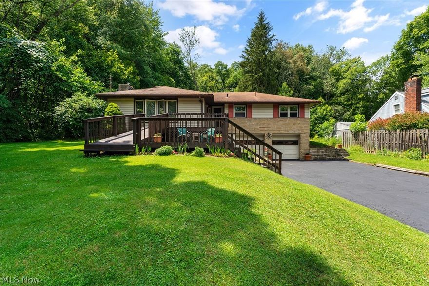 All of the charm you could imagine in this custom built raised ranch home. The owners have taken extra care in maintaining this clean and orderly home. A two- tiered deck greets you as you approach the front entrance. The back yard is surrounded by woods and offers lots of privacy for relaxing around the firepit.
Upon entering you will be pleased to see the oversized living room with fireplace and beautiful woodburner. The large eat-in kitchen has room enough for a table to seat 8-10. The cabinets are clean and solidly built with an added adorable farmstyle side board and extra counter space. There is a convenient updated 1/2 bath just off the kitchen. The bedrooms showcase hardwood floors and lots of closet space. You can also access the home via the driveway (lower-level) which brings you into a great little mud-room/laundry room. The lower level also has a small rec room and utitlity-storage area. Home was waterproofed by Ohio State waterproofing by previous owners. Brand new septi