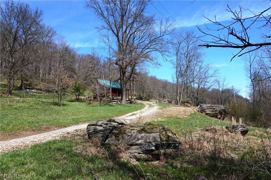 Special 35 acre getaway property outside Glenmont, Ohio that has it all.  A beautiful cabin sits on a gradual hillside that overlooks the valley where two creeks join together.  Just on the other side of the creek is a field and nice long pond.  A 28 X 56 pole barn is just beyond the pond, fenced to keep horses or farm animals.  Behind the cabin is about 18 wooded acres for your recreational enjoyment.  Freshly planted chestnut trees will be producing in the years to come.  On the south side of the road the property has access to the Holmes County Trail for horseback riding, biking, running, and hiking.  Call today for your private showing.