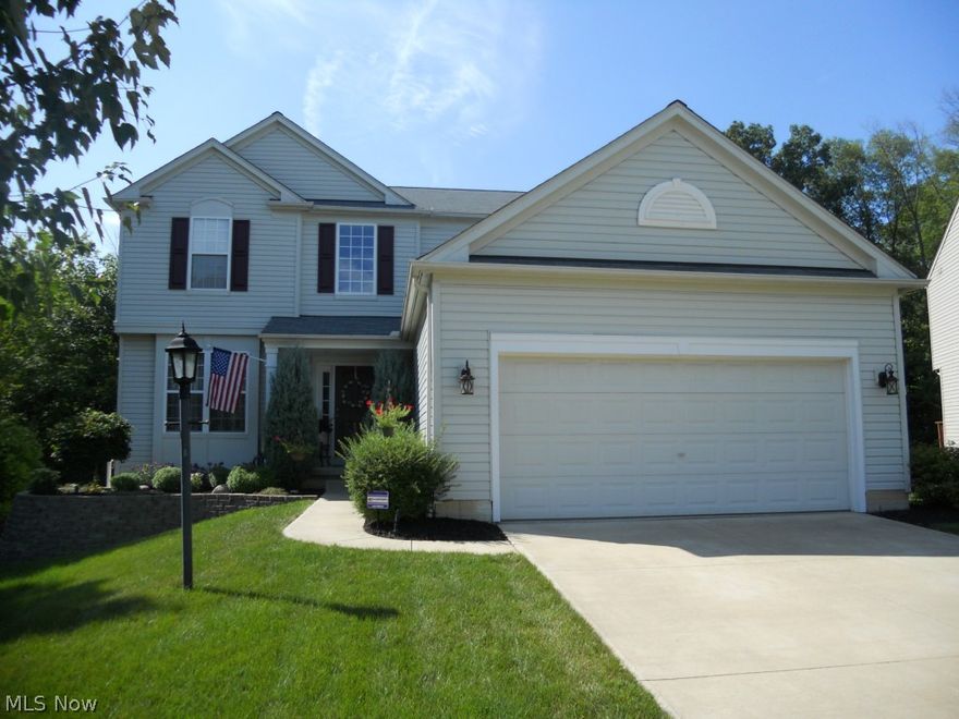 Stunning colonial proudly boasts clean lines.  Impeccably maintained with Spanish hickory flooring thruout the main floor. Continues upstairs to hallway. Open floor plan with an abundance of windows. Situated at the edge of the cul de sac with wooded side yard and park like setting at rear yard. All rooms freshly painted in 'today's colors' with finished full basement, custom wet bar, 5th bedroom, full bath with tiled shower to 10x42 storage area. Amazing kitchen overlooking the family room with gas fireplace. Large eating area 16x9 with vaulted ceiling, walls of windows to slider to newly reconstructed large deck featuring wrought iron railings. Spacious master bdrm with glamour bath and 3 additional bedrooms. Truly House Beautiful!!