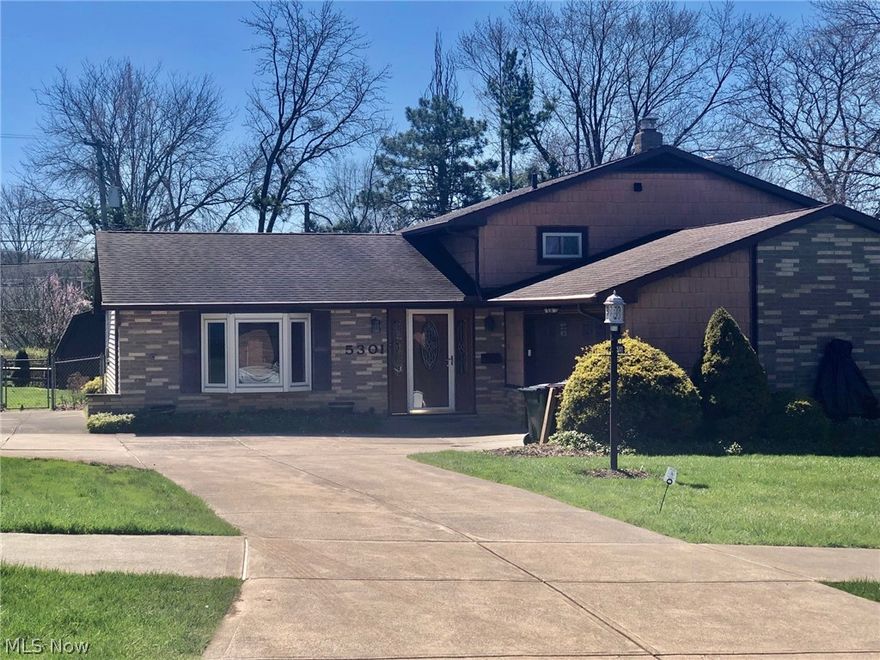 Very spacious split level home located in Woodbury Hills. Main level has a remodeled eat in kitchen (2024), white cabinetry, newer laminate flooring, lighting, bay window and all appliances stay. Newer flooring in foyer entrance that leads to formal living room/dining room combination  with a large picture window looking to the backyard brings tremendous light in.  Three large bedrooms, master bedroom has two closets.  Full bath has double sinks, separate tub and shower. Family room with wood burning fireplace and beamed ceilings has a slider that leads to the backyard. Half bath and laundry room with washer/dryer in the lower level.  Fenced backyard has a brick patio perfect for summer bbq's. Central air,  Shed has electric,  attic spaces offers storage. Attached two car garage convenient to bring in the groceries. Cement pad for extra parking. This home has so much to offer!