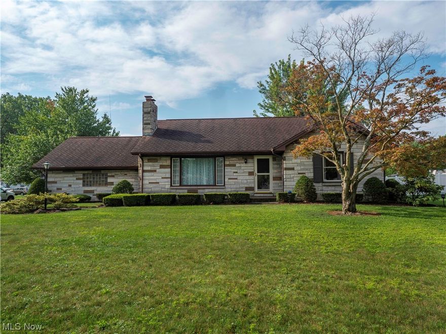 Welcome to this beautiful and unique full stone exterior ranch home set on a large 2/3 acre corner lot. This 2 bedroom 2 bathroom home is move-in ready and boasts hardwood flooring throughout the home. Walk up to the front of the home and be greeted by a large porch before entering into the foyer. On one side of the home are 2 large bedrooms each with abundant closet space. There is an eat-in kitchen with a large picture window looking into the backyard for informal dining as well as a separate dining room also with a picture window looking out into the back yard for those more formal dinners. The enormous living room is flanked on one side by a wood burning fireplace adding warmth and character to the room even when not in use. The unfinished basement has a bathroom and  unlimited potential to suit your needs. While the garage does not have direct access to the home, there is a covered walkway from the garage to the back of the home. The backyard is partially fenced by a 6 foot privac