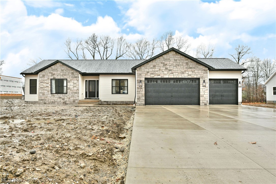 Lose yourself in the bespoke styling and must-see craftsmanship of this all new, custom-built Howland home! Located in one of hottest developing neighborhoods, the visually striking residence is ready to put the heat wave on these cold winter days. Immediately captivating with its unique stonework, the home leads you up the oversized concrete drive and past the three-car garage to a covered entryway. Inside, the elegant foyer reveals an open central layout that will take your breath away. Cultured colorways and material choices quickly direct eyes to the profound concrete mantle and nearby kitchen with its polished stone countertops that waterfall down both sides of the floating island. Stainless brightwork contrasts the warm wood cabinetry and tiled backsplash. Meanwhile, enjoy a casual meal in the window lined dining nook for illustrious backyard views. Sleek, black accents continue into the brooding master bedroom suite with its opulent wall treatment. The combined master bath mirrors the cues with its endearing stall shower and backlit vanity. A full walk-in closet hides away nearby. Opposite the home, a pair of inviting guest bedrooms bring equally impressive storage space, tall ceilings and ceiling fixtures as they’re separated by a charming full bath.