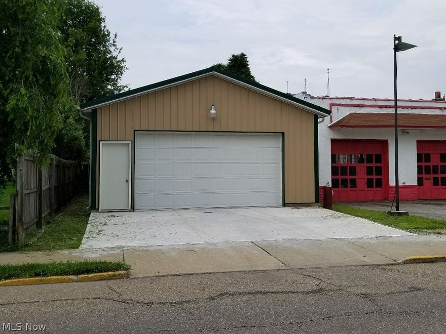 Amish built in 2014 this 24' x 100' pole style constructed building has 10' rafter height, 16' insulated garage door, steel man door, fully insulated walls covered with OSB, insulated open ceiling, 200 amp electrical service, electric F/A heat with Central Air, concrete floor, garage door opener, exterior security light and fluorescent lighting. The exterior is all metal and maintenance free. Zoned commercial this building can be used for most anything or modified to fit your needs. Currently it is open span with no interior walls. Heating system is suspended leaving full use of the 2400 square feet of floor space. This building is perfect for antique cars, wood working, machine shop work, storage etc....  It is basically the size of 4 standard 2 car garages. Located directly on North Fourth Street near the police station and city building.