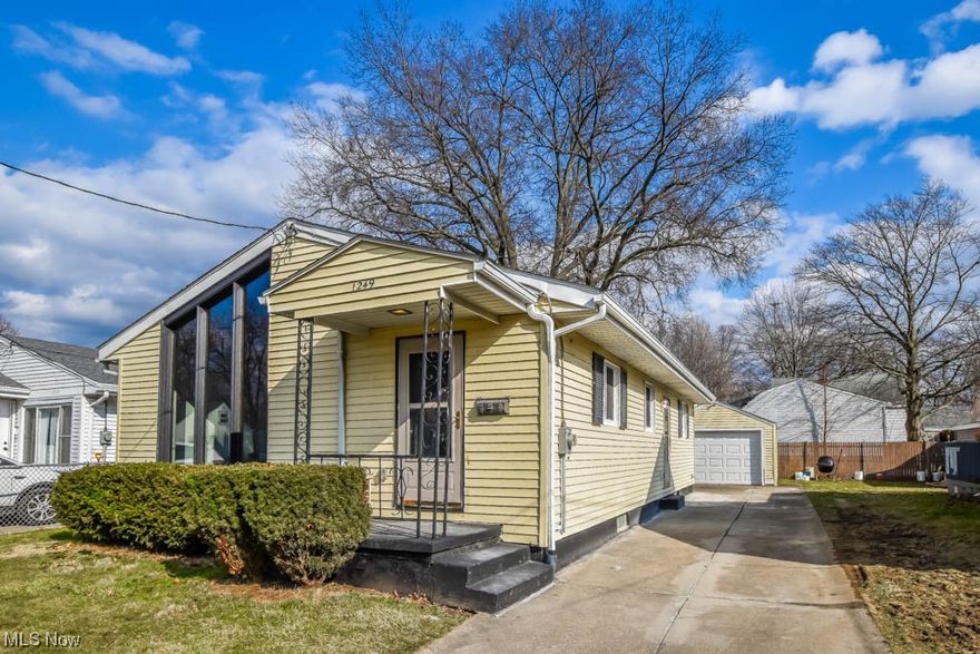 Come take a look at this updated North Akron ranch featuring 3 bedrooms, 1.5 baths, and a finished lower level! Recent improvements include new windows, flooring, lighting, garage door, water heater, and so much! The vaulted great room surprises with a wood planked ceiling and floor-to-ceiling architectural window. Explore the new kitchen with butcher block counters, white cabinetry, trey ceiling, and shiplap accent wall. Three bedrooms and a renovated full bath with extended vanity and tub/shower with a decorative tile surround complete the main level. The lower level offers an extra 500 square feet for entertaining, boasting a built-in bar area and convenient half bath. Outside, enjoy a patio and detached garage in the partially fenced backyard. Don't miss out on this unique find, call today!