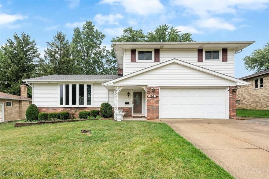 Welcome home to this well maintained split level home located in the desirable area of Parma's Southeast Side. Boasting 4 large bedrooms, 2.5 bathrooms and over 2,100 sq ft of finished living area, there is no shortage of space here! As you enter the home, you'll be greeted by an abundance of natural light from the beautiful bay window, showcasing a huge living and dining room. The eat-in kitchen provides ample countertop and cabinet space. The lower level family room is open to the kitchen and provides a great space for entertaining. The sliding glass door opens to the concrete patio overlooking the nearly 1/3 acre yard. A half bath completes the lower level. Upstairs you will find 4 bedrooms with gorgeous original hardwood flooring in excellent condition. Each bedroom features multiple windows and large closets. A full bathroom completes the second level. The basement features a large recreation room, 2 large storage areas as well as an additional bathroom, workbench and laundry area. This home features great curb appeal with newer vinyl siding, newer roof and vinyl windows. A one year home warranty is being offered for peace of mind.