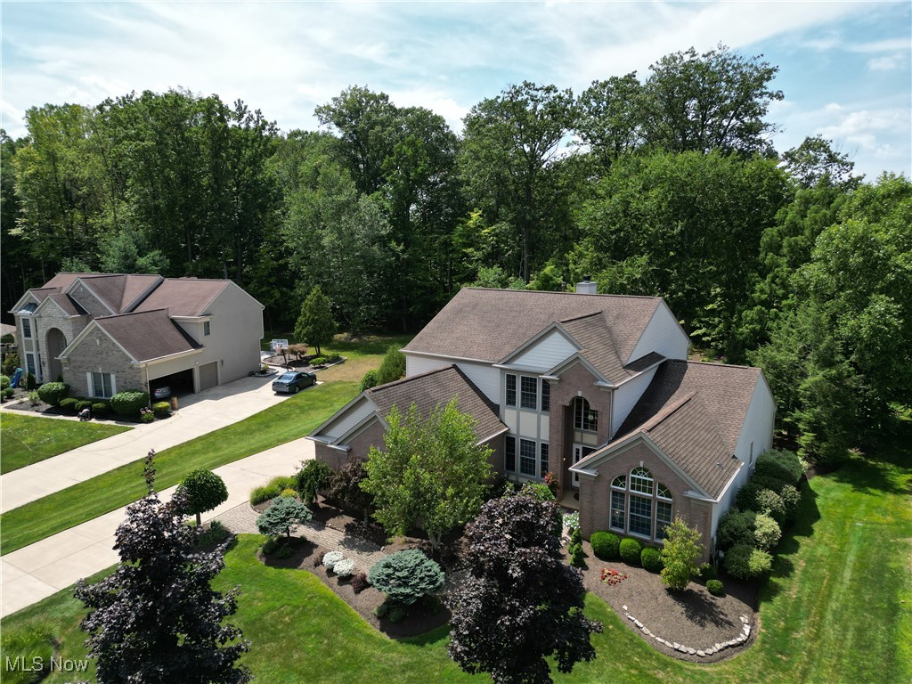 Welcome to 1470 Fireside Trail, a stunning luxury colonial in the sought-after MacIntosh Farms community of Broadview Heights. Tucked on a peaceful cul-de-sac and backing to the scenic Briarwood Golf Course, this home offers over 4,000 sq. ft., 3 bedrooms with a possible 4th bedroom by converting the loft, 2.5 baths and a first-floor primary suite. Enter to teak floors and soaring 19-ft ceilings flowing from the foyer into the great room and kitchen. Off the foyer are a large office and formal dining room. The great room features a double staircase and double-sided fireplace shared with the huge eat-in kitchen. The remodeled kitchen (2009) boasts granite counters, glass tile backsplash, large island, and stainless appliances. Patio doors open to a wooded backyard oasis with golf course views, deck with lighting, paver walkways, fountain, and professional landscaping with irrigation. The primary suite offers high ceilings, walk-in closet, soaking tub, and double sinks. Additional main floor highlights include a laundry room and half bath. Upstairs has a loft with large closet, 2 spacious bedrooms and a full bath. The high-ceiling basement is roughed for a bath and ready to finish. Extras include a 3-car garage, custom window treatments, kitchen water filtration system, whole-house humidifier, 30-year roof (2011), HVAC (2017), and a home warranty. MacIntosh Farms amenities include 3 pools (one with lap area), pavilions, playgrounds, tennis & basketball courts, and the “Red Barn” community center. Residents enjoy pool passes and easy access to Cleveland Metroparks and the Broadview Heights Rec Center. Call today to schedule your tour to see all that this wonderful home has to offer in a highly sought after community!