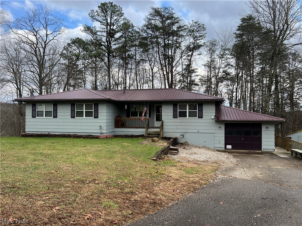 3 bed 3 bath house 1 car garage. Country setting on 1 acre lot. Nice open dinning/ living room with hardwood floors and Glass sliding doors leading out to Large deck over looking wooded back yard/wood area. Full basement with walkout to back yard. Metal roof. pellet stove as well as propane furnace. 2 outside storage buildings...You don't want to miss this ......