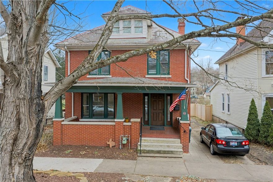This beautifully maintained brick home situated along a historic brick street, offers timeless charm paired with modern updates. Enjoy off-street parking with a 2-car garage featuring lower-level storage, plus a lower yard with convenient alley access. The oversized front porch is perfect for relaxing and taking in the neighborhood surroundings. Step inside to an impressive oversized foyer, highlighted by an original mantel, window seats on both sides, and a gas log fireplace professionally installed by Wittekind Chimney Sweep. The foyer showcases the original staircase and opens to the living room, featuring pocket doors, a decorative fireplace with its original mantel, and a stunning original leaded-glass window. The flow continues to the formal dining room, which features its own unique decorative fireplace and mantel, accompanied by charming glass-door shelving on each side. The custom remodeled kitchen—by Harrison Construction in 2013—offers quartz countertops, an abundance of cabinetry, subway-tile backsplash, glass-front accents, oversized drawers, and a bright breakfast area surrounded by windows leading to the back deck (4 years old) and yard. Upstairs, you’ll find a spacious primary suite with a professionally updated bath (Harrison, 2015), along with two additional bedrooms and a second remodeled full bath with granite countertops. Walk-up attic provides potential, including one partially finished room—ideal for future expansion. Full basement includes a third full bath, laundry area, generous storage, and a workshop space with a convenient side door at steps for exterior access. Lovingly cared for, this home blends historic character and modern improvements while still showcasing original wood floors, crown molding, and pocket doors— it's time for the next owner to continue the tradition. Drake Const has checked roof every two years (inspection spring of 2025; Morrisons services HVAC twice a year. 2025 gutter drain work completed and drylocked basement.
