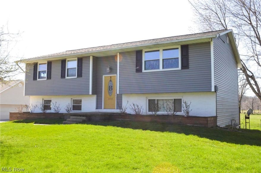 Beautifully remodeled home in a country setting has easy access to the I-77 & Akron Canton Airport. Home has been professionally designed & remodeled throughout! Mstr Bdrm Suite w/walk-in closet w/ designer cutloop carpet & EnSuite Mstr Bthrm w/ slate flooring & tub/shower surround. Home has HUGE 24' x 18.6' Family Rm w/ 4 windows & set of French Doors that walk out to concrete patio/driveway, Pole built oversized Garage & awesome back yard almost an acre, flat, has GREAT soil for gardening! Upper level boasts an Open Concept space w/ Living Rm completely open to Dining Rm can accommodate 8-10 diners, open kitchen w/ eat in/ island area! Kitchen accented by Bolon Kitchen cabinetry in Espresso & Stainless Steel pulls, Bianco Antico granite countertops & handscraped hardwood wide plank flooring! Stnlss Stl appliances in Frigidaire Gallery Collection & Whirlpool Fridge/Freezer. Dining Rm flows & same hardwood flooring has 2 trimmed write-on panels. Living Rm w/sculpted designer cut loop c