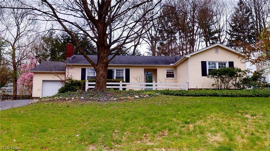 This home is waiting for it's new owners! A short walk to the University and downtown Kent! Charmingly situated, this four-bedroom ranch has hardwood floors and crown molding throughout the main floor. Champion insulated windows let in the sunlight and views of mature trees from the front yard and private back yard. Stand on the slate floor of the entryway to see the living room with its 12’ thermal picture window and gas fireplace. The eat-in kitchen with marble counter tops, custom hardwood glass-front cabinets and a built-in desk is adjacent to the entryway. Den has quarry-tile floor, solid wood built-in bookcases and cabinets with an ergonomic slide-out computer shelf, two walls of Pella floor-to-ceiling windows and an over-sized sliding glass door that leads to the patio w/gas grill hook up available and a tree-lined backyard. Downstairs, enjoy a finished family room plumbed for a wet bar but also a cozy, bright, sound-insulated home office with custom shelves and desk, a laundry