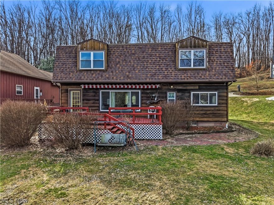 So much potential awaits at this lakefront cottage featuring a spacious open floor plan. Step into the kitchen to find warm wood cabinetry and an inviting dining area that seamlessly flows into the living room, where water views take center stage. A glass door leads out to the deck, creating the perfect space for relaxing or entertaining. Tucked away for added comfort and privacy, the first-floor primary bedroom is perfectly positioned for sunset gazing. This level also includes a full bath and convenient laundry area.
Upstairs, you’ll find three generously sized bedrooms with ample closet space, along with another full bath featuring cedar walls—an excellent foundation for future remodeling. With new flooring, fresh paint, and updated fixtures, this home could truly shine and significantly increase in value. Whether you’re looking for your next family getaway or an investment and resale opportunity, this property offers incredible potential. Enjoy all the amenities of Guilford Lake, complete with your own private dock and a boat included. An additional lot located across the street features a spacious two-car garage, providing extra storage and convenience. Several mechanical updates have already been completed, including a brand-new roof in Nov of 2025, plus a hot water tank and furnace installed in 2023. *The Guilford Lake dam project is steadily progressing, with plans to have the lake refilled by Spring 2027. Additional information is available on the ODNR website.*