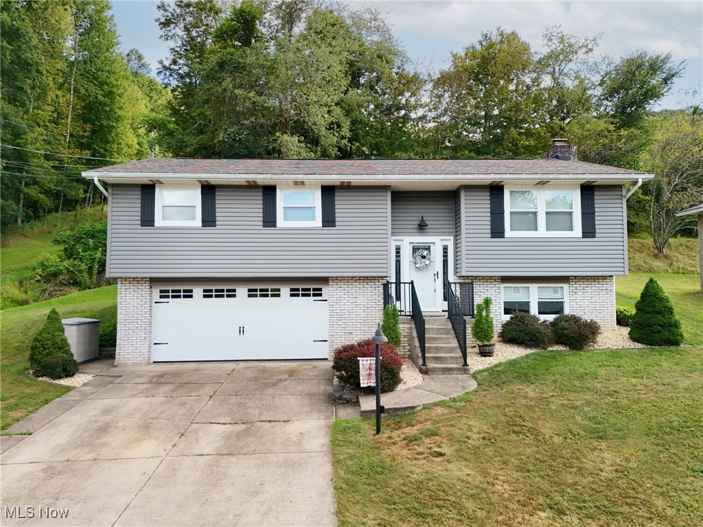 Load the truck, you're moving! The home you've been hoping would come on the market has arrived! This wonderful 3 bedroom, 2 bath split entry home located in desirable Country Club Estates, Weirton WV is ready for you. The thoughtful owners have recently made so many improvements including an updated roof in 2017, new vinyl windows, vinyl siding and shutters 2024, beautiful luxury vinyl flooring throughout the main level with 4" solid oak moldings just completed this year, renovated kitchen in 2020, electric heat pump 10 years old, newer garage door with opener, entry doors and so much more. This home has been so lovingly cared for, the next owner can move right in with peace of mind and just enjoy life. A french door off the dining area leads to a private deck with built in bench space perfect to have morning coffee. 2 car garage with shelving and shed in the back yard for lots of storage space. You can't wait to call on this one!