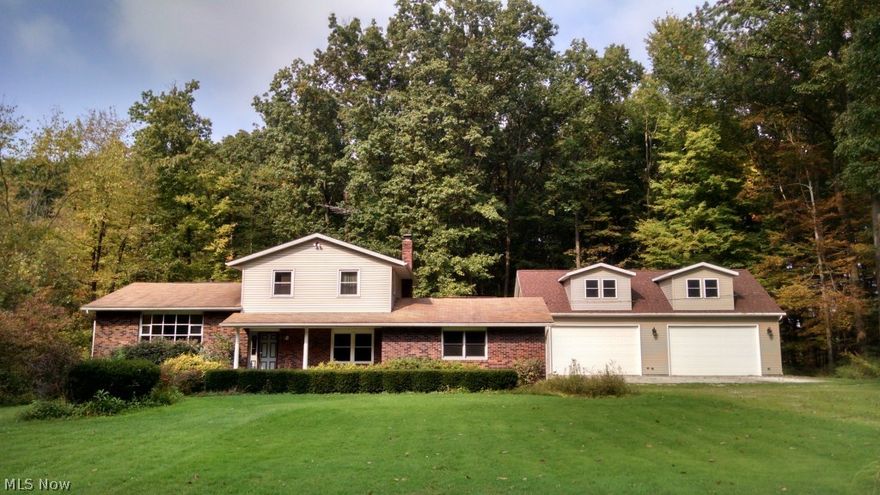 Welcome to seclusion! 30x50 building with heated floors, lift, bath and loft.  Beautiful home situated on 5 acres. Mineral rights transfer to buyer! Close to Berlin Lake.  Three bedroom home with 2 1/2 baths.   Two car attached garage plus an 8x10 shed.  A bonus room with heated floors and a fireplace from this room you can go outside and enjoy the deck with a great view. First floor laundry and office is next to newly updated 1/2 bath.  Furnace is only 2 years old   A osmosis water system is also included in this wonderful home.  Seller may entertain any allowance for additional updates. Call for your private tour today!