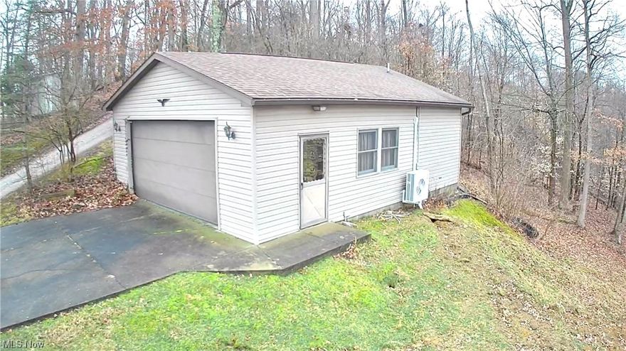 Endless Possibilities for this piece of property near Seneca Lake. Located .6 miles past the Beach entrance is this 768 SQ FT Garage/Apartment combo that comes with a Kitchen, Full Bathroom, Laundry, and large open concept living space. This property is ready to be transformed into whatever you can imagine. You can keep it as a Garage/Apartment combo and build a new home or transform the interior into a full residential space. This property comes with 1.13 acres, county water, new septic in 2023, wall mount propane heater, Mitsubishi wall unit for heat/AC and Camper/RV hookup. You may have seasonal views of the lake from the front yard. The surrounding lake amenities include .6 miles to the Beach entrance, 2.6 miles to the Boat launch and about 3.1 miles to the Marina. So, if you like to just relax, fish, swim or boat then schedule your showing today to see if this could be your lake home!  Drone photos do not show the property lines just the area views.