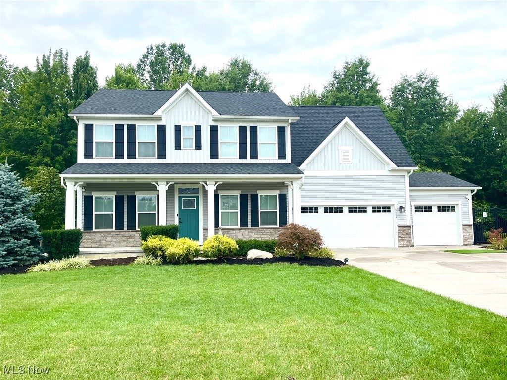 Welcome to 5519 Schueller Blvd., a 6-year-young builders model colonial thoughtfully designed for today's living. A charming covered front porch sets the tone, offering an inviting spot to enjoy the neighborhood. Step inside to discover a modern open floor plan. The versatile front room can serve as a formal dining area, cozy sitting room, or home office. The spacious kitchen features abundant white cabinetry, a breakfast bar, and plenty of counter space, flowing seamlessly into the great room making it the perfect hub for everyday living and casual entertaining. Luxury vinyl plank flooring throughout the main level adds a warm, natural ambiance. A handy mudroom with a half bath adds smart functionality. Upstairs, the loft offers a quaint retreat (and possibly a 4th bedroom), while the convenience of a second-floor laundry epitomizes practical luxury. The homes three bedrooms include a spacious primary suite with two generous walk-in closets and a private full bath with dual sinks and a pristine walk-in shower. Each bedroom provides a comfortable retreat and a blank canvas for your personal style. The unfinished basement is a vast expanse of potential. Ready for a home theater, gym, or additional living space. Step outside to a covered back deck with views of the fenced yard and wooded backdrop, creating a private and tranquil setting. A rare three-car garage ensures ample space for vehicles and storage. This home offers the benefits of a nearly new build with thoughtful enhancements, plus easy access to the highway.making it a commuters dream. Experience the blend of comfort, convenience, and modern living at this Sheffield Village beauty. Your new home awaits!