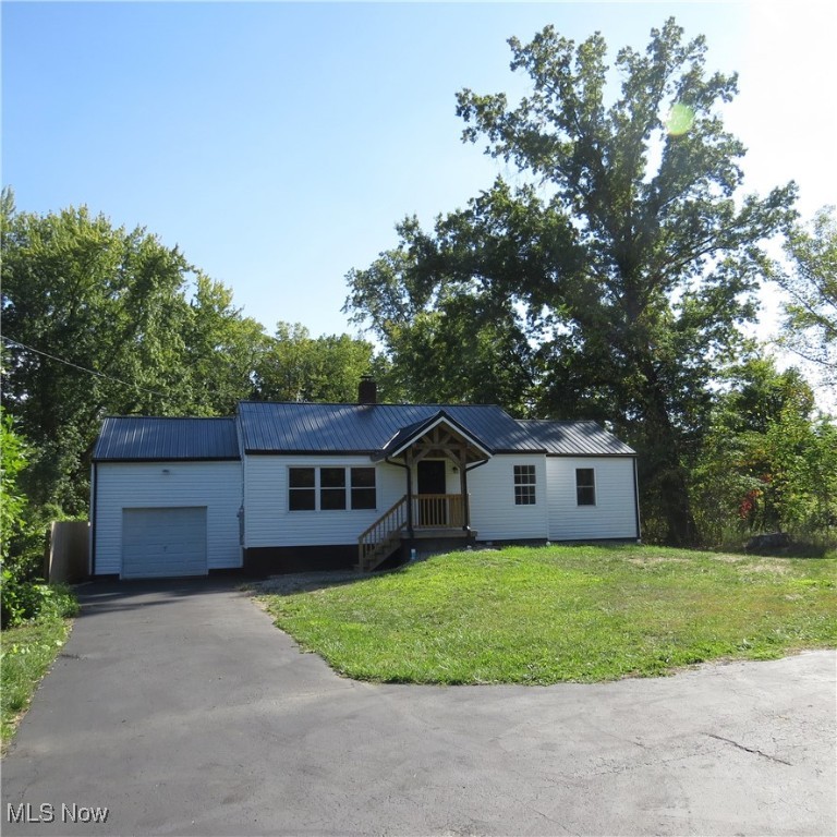 Take a look at this newly remodeled ranch home! This 3-bedroom, 1-bathroom residence is situated on a spacious 0.920-acre lot. Upon entering, you'll find a large, open living room with abundant natural light from numerous windows. Adjacent to the living room is the kitchen, which offers convenient access to the attached garage. Continuing down the hall, you'll find the full bathroom and three bedrooms. The home also features a full, unfinished basement providing ample storage space. This property has undergone extensive updates in 2025, ensuring peace of mind for the new owner. These updates include: New Metal Roof, New Siding, New Gutters, New Front Porch, New Back Patio with Stamped Concrete, New Concrete in the Garage, New Sewer Line, New Heat Pump for Heating & Cooling, New Flooring & Fresh Paint throughout, and more! Don't miss the opportunity to own this charming, turn-key home. Schedule your showing today!