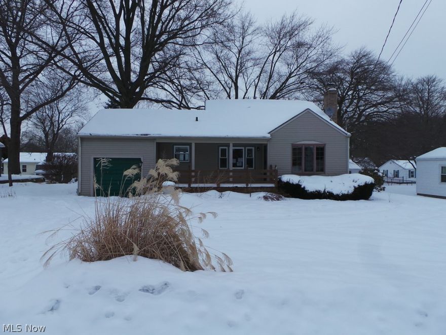 Three bedroom cape cod on deep, partially fenced wooded lot.  Attached garage, updated kitchen with newer floor.  Wood floors in BR's & DR.  Marble & brick FP.  Rec room in basement.  Property sold AS IS.