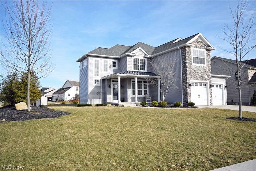 Welcome to this one of a kind, craftsman style home.  From the moment you enter the 2 story great room with stone fireplace, you will love the open floor plan and unique custom design, including 4 bedrooms and 2.5 baths.  This quality built home offers many windows, providing abundant natural lighting, along with 3 sets of sliding doors opening to the covered porch.  Beautiful professionally landscaped yard, with custom Amish built potting shed/outbuilding.  Granite counters in kitchen and all baths, with dark maple soft close cabinetry.  Enjoy the neutral decor with wood floors throughout the majority of the first floor, and ceramic tile in upstairs baths.  Two car garage with additional storage and poured concrete foundation in a family friendly neighborhood with top rated schools.  No worries as this ones comes with America's Preferred Home Warranty! Call for your private showing today! This property is agent owned.