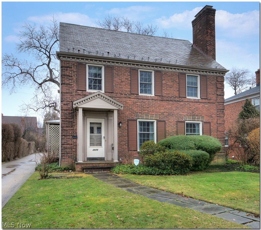 Welcome home! This charming brick colonial has been lovingly lived in by present owners since 1967. They have made many improvements including new(er) garage and windows. The first floor has a large foyer entry, living room with fireplace and hardwood floors, dining room with hardwood floors, family room addition, and eat-in kitchen. The second floor has three bedrooms and a full bath that includes both a stall shower and tub. The third floor has a large bedroom and is rough-plumbed for a bathroom. The lower level includes a carpeted recreation room with a wood burning fireplace, a workroom and storage. There is a cedar closet on the third floor. Character, curb appeal, and conveniently located to shopping, hospitals and University Circle.